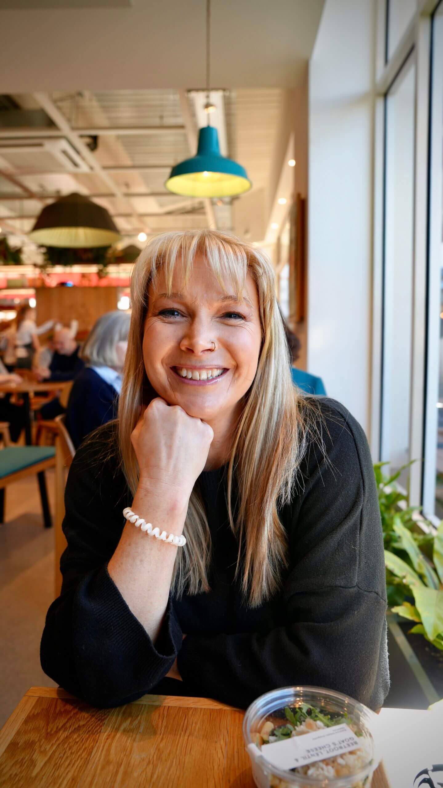 Becky Stone seated and smiling in a grey top – a warm, trauma-informed counsellor supporting people with depression, eating disorders, and emotional healing.