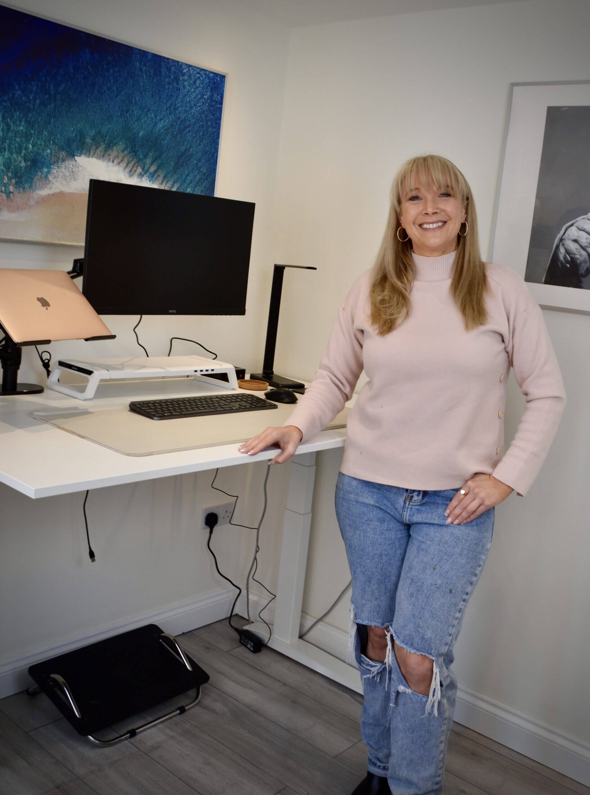 becky-stone-therapist-ozempic-blog Becky Stone smiling at her desk, a therapist specialising in eating disorders and body image support.