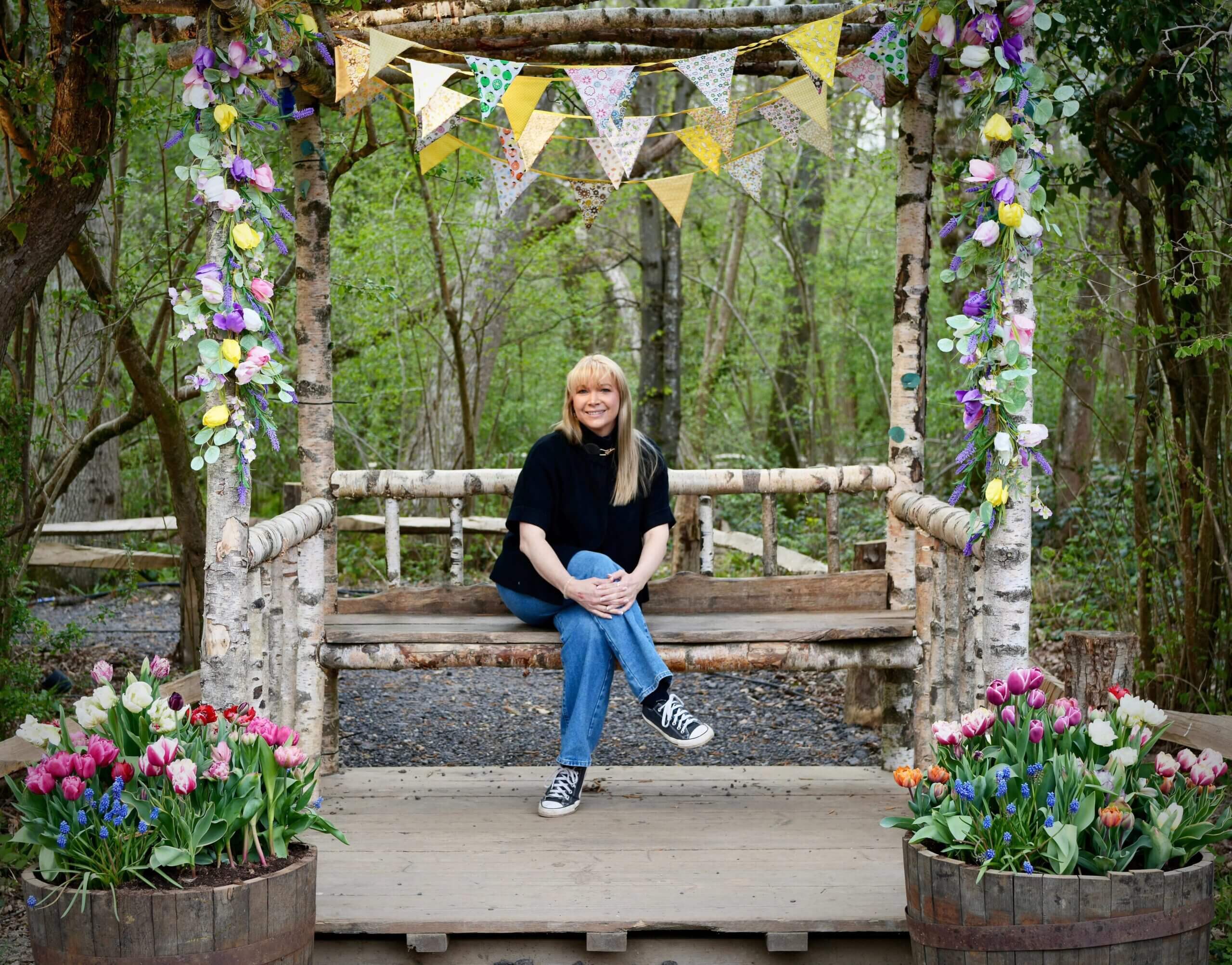 Becky Stone ADHD Therapist Walk and Talk Canterbury Becky Stone, ADHD therapist in Canterbury, sitting on a bench in a peaceful forest setting, offering walk and talk therapy for neurodivergent clients