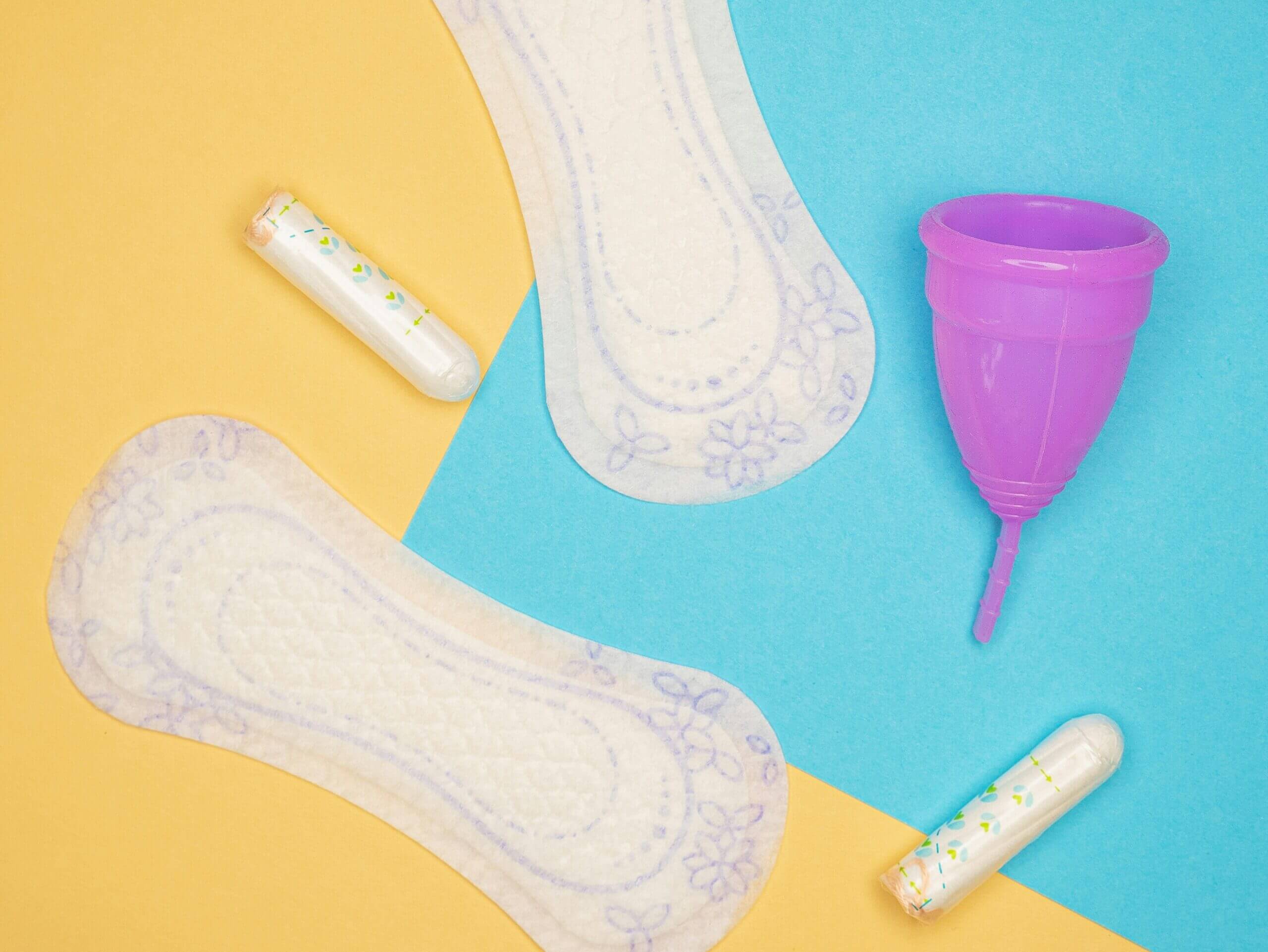 reproductive-health-supplies-coalition-P2Du_JLP5hA-unsplash Illustration of menstrual products — pads, tampons, and a cup — supporting PMDD education
