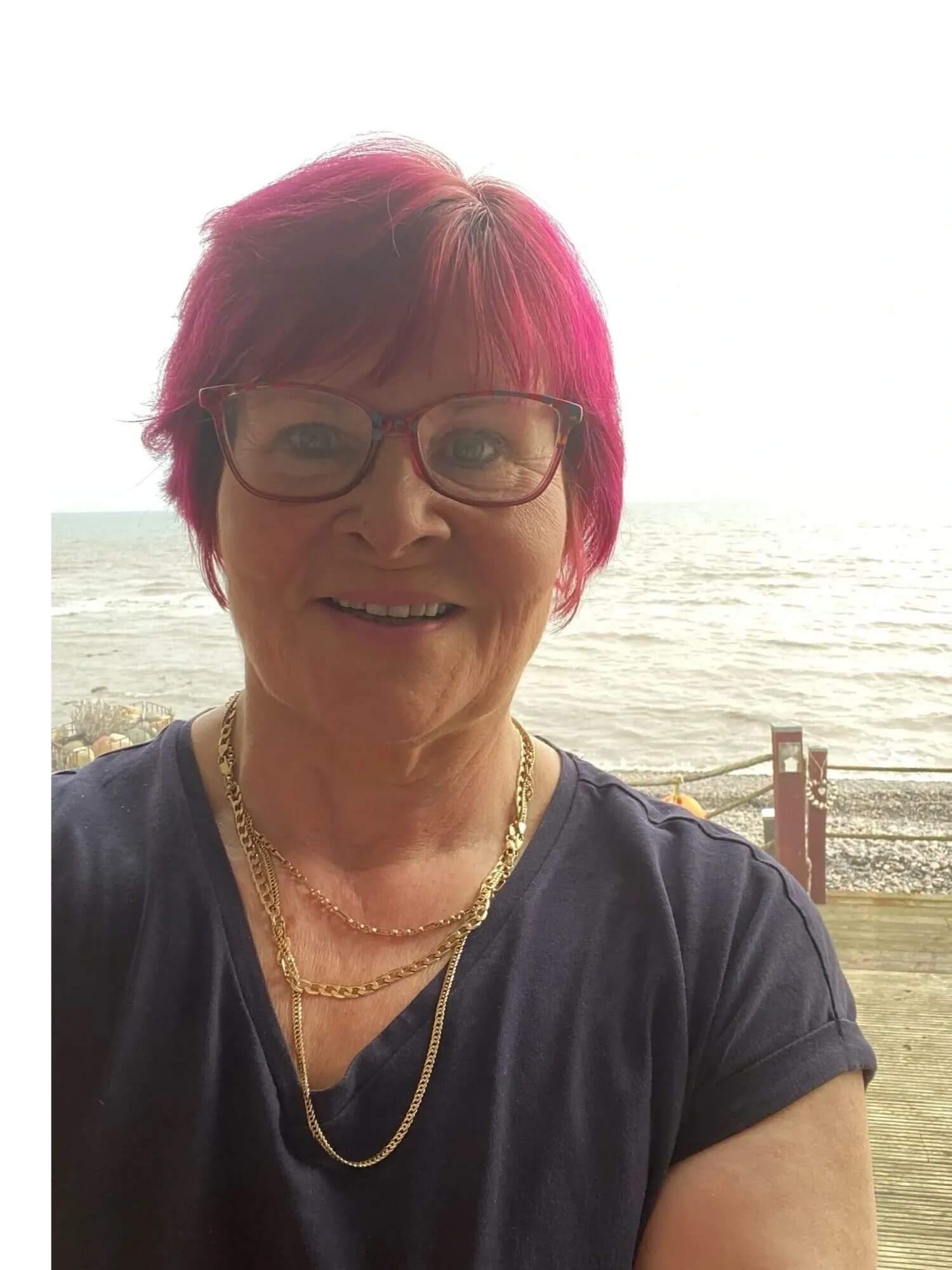 Smiling midlife woman outdoors in natural light, representing calm, balance and wellness support through magnesium