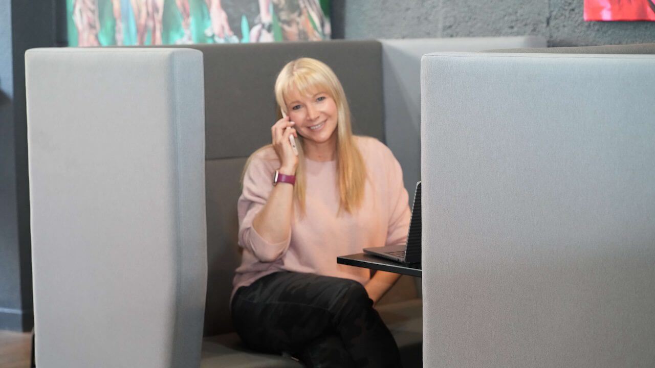Becky Stone smiling while holding a phone, reflecting on healthy tech boundaries