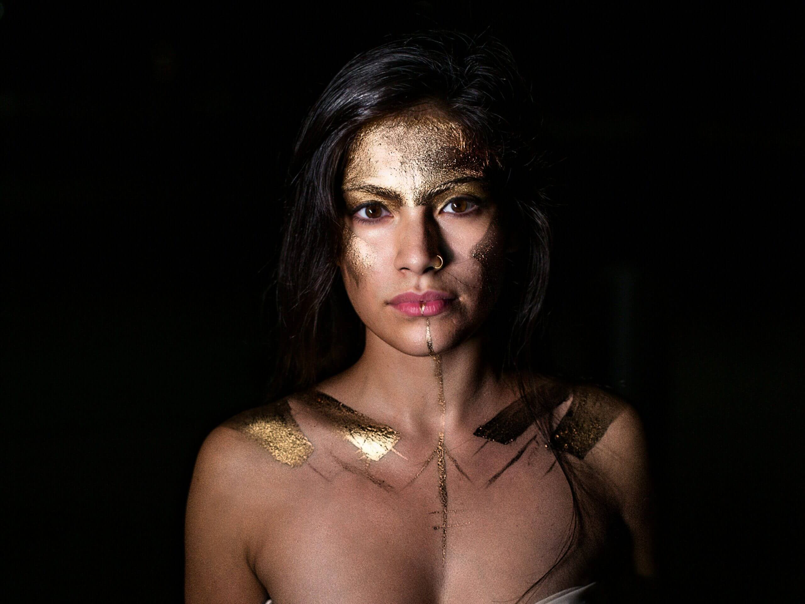 Symbolic image of a woman shielding her face with flowers – representing emotional boundaries, identity, and self-protection in therapy
