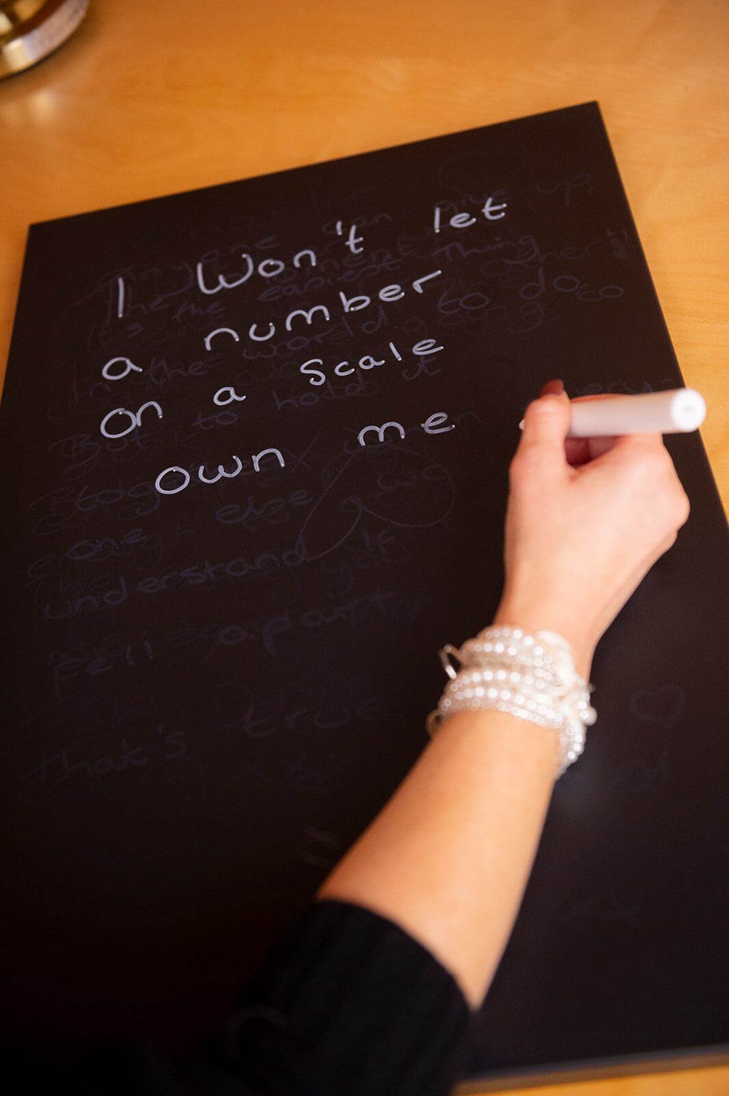 Hand writing the word EAT on a chalkboard, symbolising eating disorder recovery, food fears, and the importance of trauma-informed therapy in Canterbury.