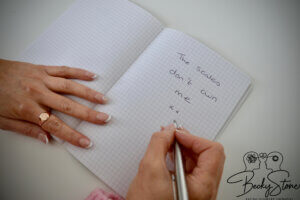 Becky Stone completing a reflective counselling exercise Becky Stone writing reflections in a notebook during an online counselling exercise